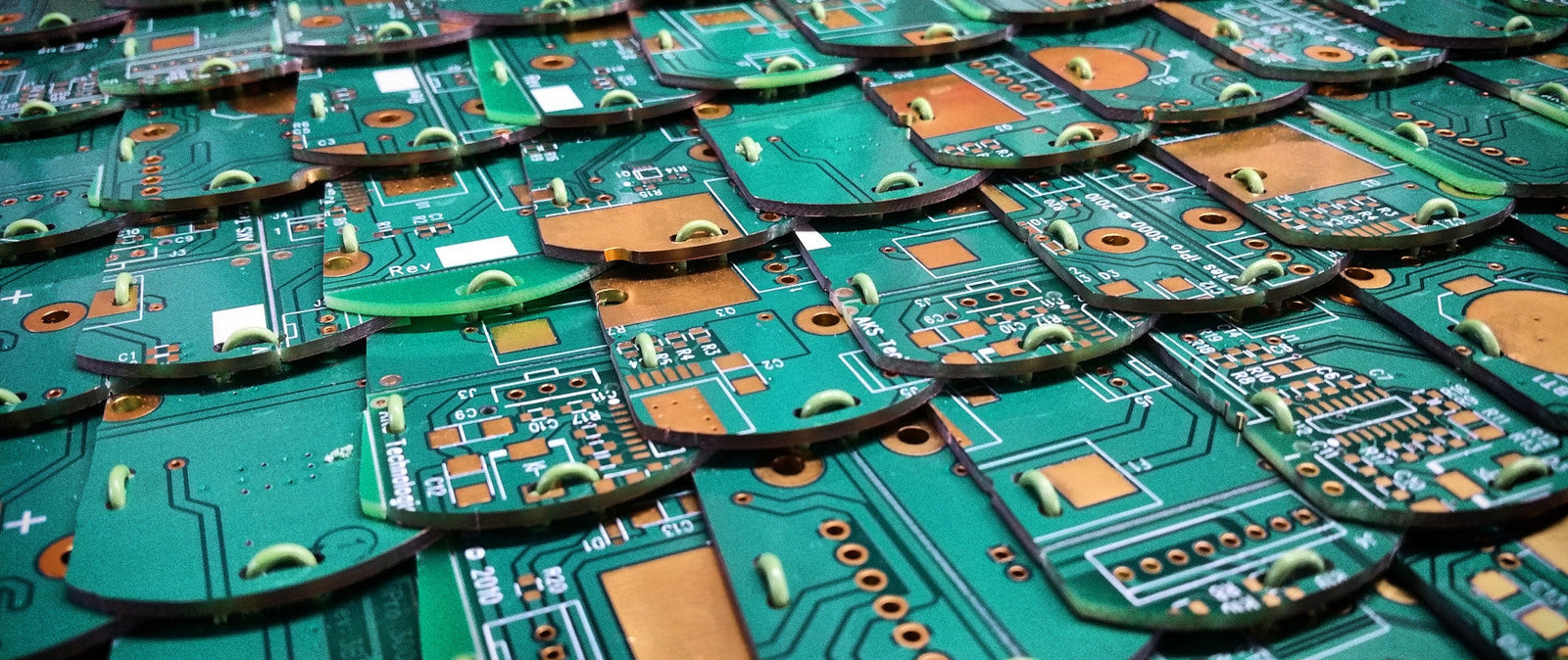 A repeated pattern of circuit board pieces stitched together in what could be a plate of armour. 
