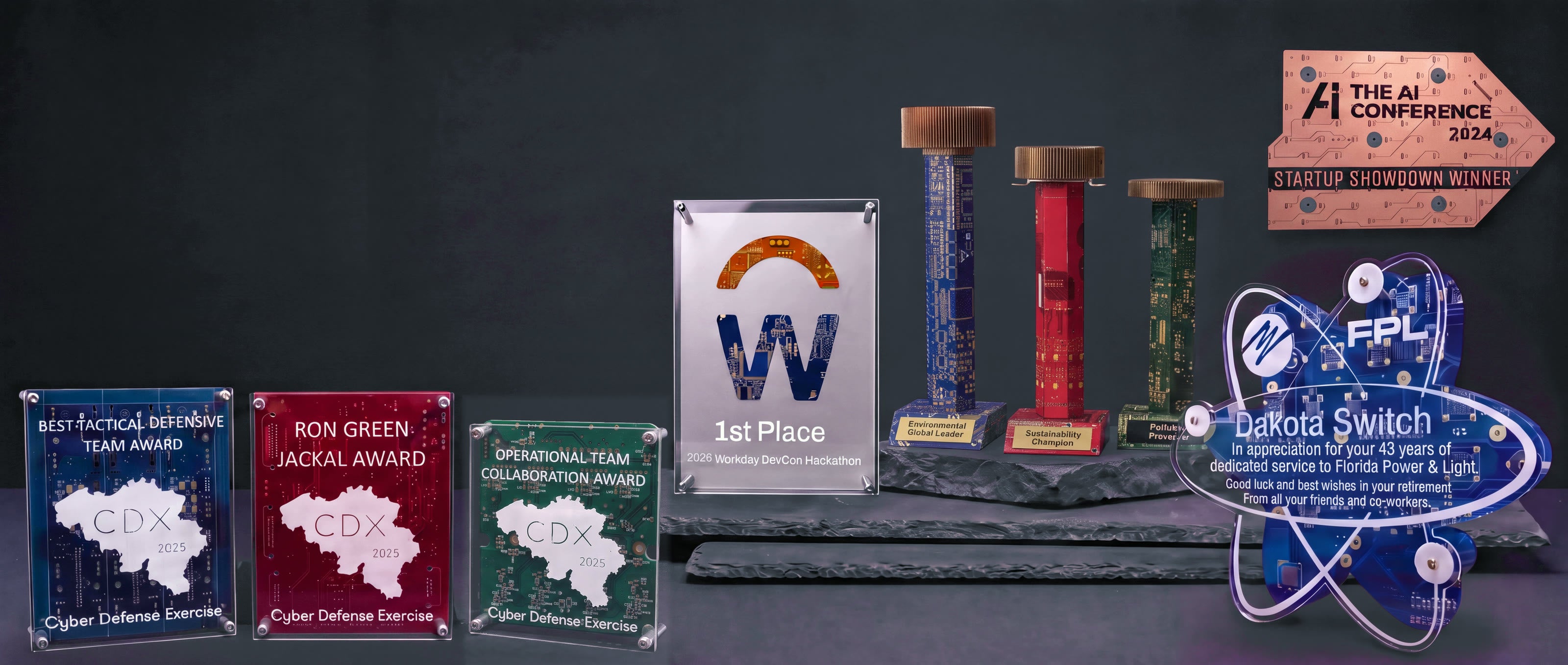 TechWears circuit board awards: standing panels, Workday DevCon float award, trophies, atom award and wall plaque